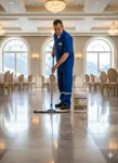 Operario de limpieza aplicando cera Jd.8M con mopa profesional en salón de eventos.